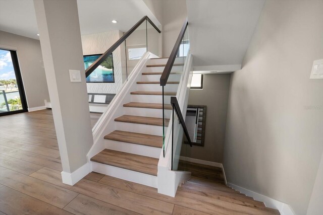 16047 Redington Dr, Redington Beach, FL 33708 - stairway featuring baseboards, wood-type flooring, and recessed lighting