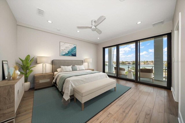 16047 Redington Dr, Redington Beach, FL 33708 - bedroom with access to exterior, a water view, light wood finished floors, ceiling fan, and recessed lighting