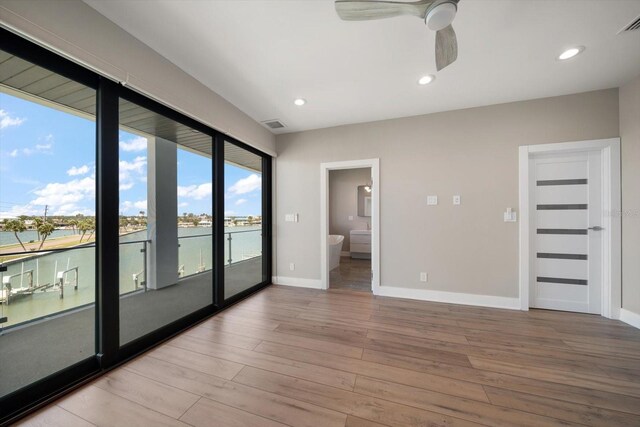 16047 Redington Dr, Redington Beach, FL 33708 - empty room featuring light wood-style flooring, baseboards, ceiling fan, recessed lighting, and a water view