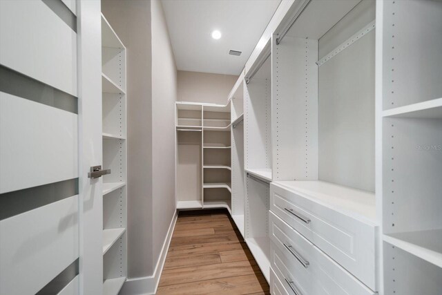16047 Redington Dr, Redington Beach, FL 33708 - walk in closet with light wood-type flooring