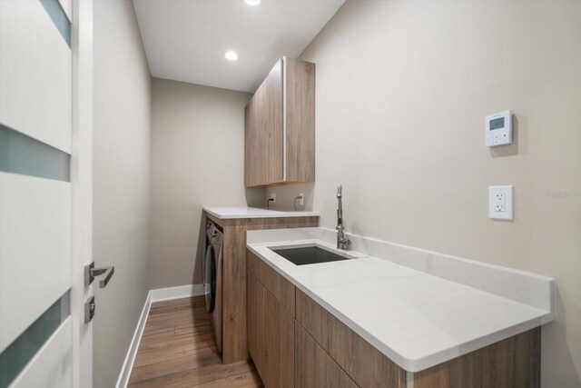 16047 Redington Dr, Redington Beach, FL 33708 - washroom with cabinet space, light wood-style floors, recessed lighting, and baseboards