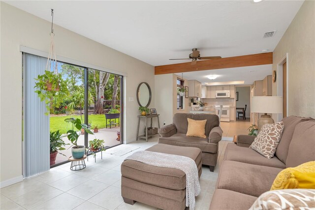 9465 126th Ave, Largo, FL 33773 - living area featuring a ceiling fan, light tile patterned floors, and baseboards