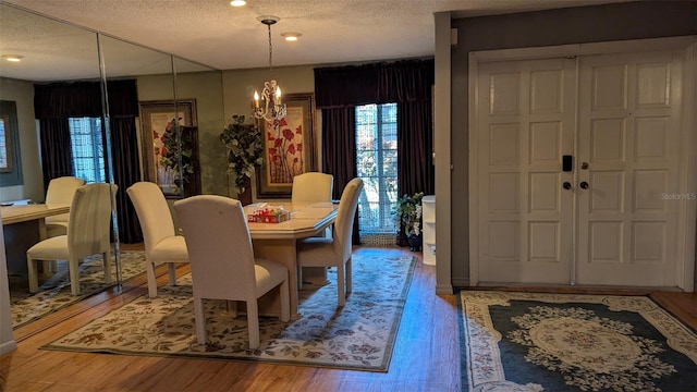 2033 Aaron Pl, Clearwater, FL 33760 - dining area with a textured ceiling, a chandelier, and wood finished floors
