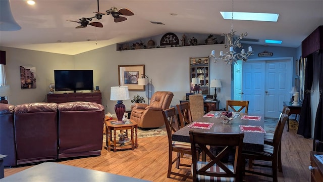 2033 Aaron Pl, Clearwater, FL 33760 - dining area with lofted ceiling, wood finished floors, ceiling fan, and a skylight