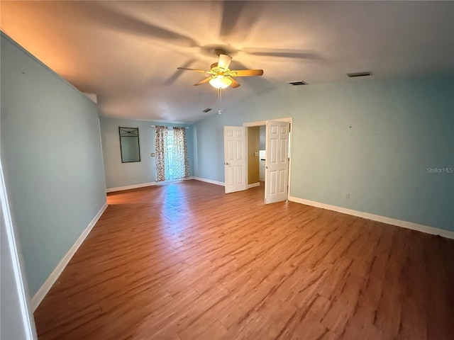 2033 Aaron Pl, Clearwater, FL 33760 - empty room featuring a ceiling fan, wood finished floors, baseboards, and lofted ceiling