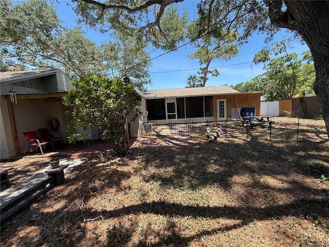 2033 Aaron Pl, Clearwater, FL 33760 - rear view of property with a sunroom, stucco siding, and a patio area