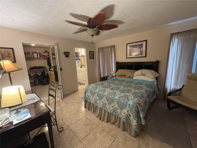 2033 Aaron Pl, Clearwater, FL 33760 - bedroom featuring a closet, a spacious closet, a textured ceiling, ceiling fan, and ensuite bath
