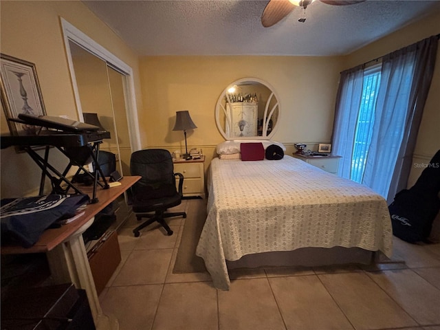 2033 Aaron Pl, Clearwater, FL 33760 - bedroom with a textured ceiling, light tile patterned floors, a closet, and a ceiling fan