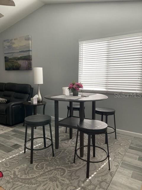 2714 60th Avenue Terrace W Unit 12D, Bradenton, FL 34207 - dining room featuring lofted ceiling, baseboards, and wood finished floors