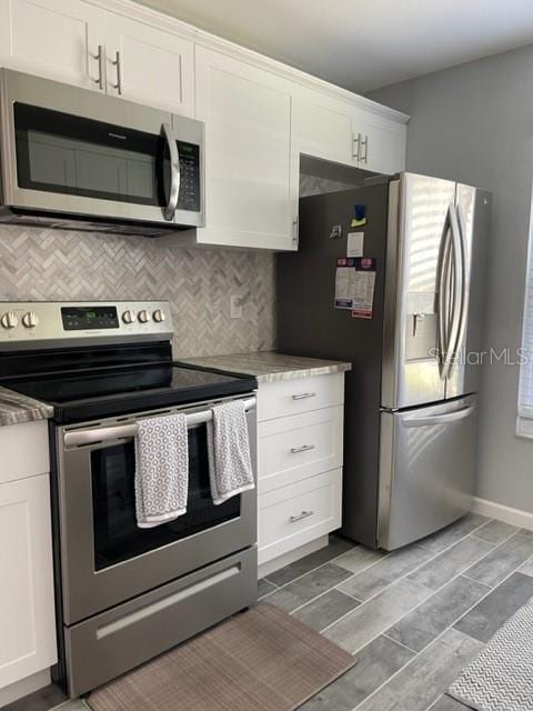2714 60th Avenue Terrace W Unit 12D, Bradenton, FL 34207 - kitchen featuring appliances with stainless steel finishes, white cabinetry, backsplash, baseboards, and wood tiled floors