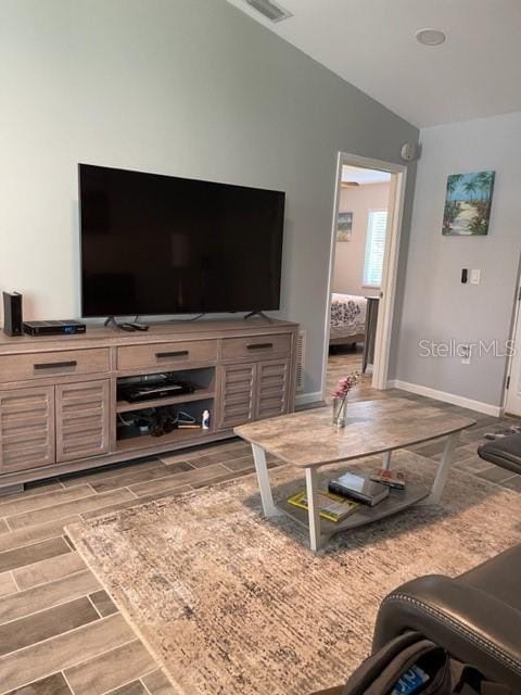 2714 60th Avenue Terrace W Unit 12D, Bradenton, FL 34207 - living room featuring wood tiled floors, baseboards, and vaulted ceiling