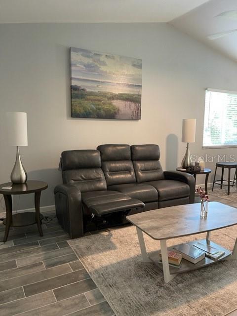 2714 60th Avenue Terrace W Unit 12D, Bradenton, FL 34207 - living area with lofted ceiling, dark wood-type flooring, and baseboards