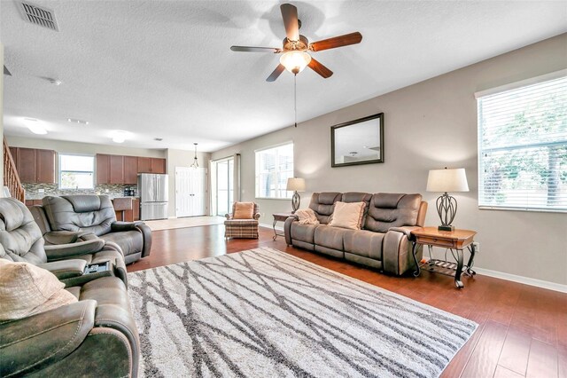 10833 Breaking Rocks Dr, Tampa, FL 33647 - living room with baseboards, a ceiling fan, wood finished floors, and a textured ceiling