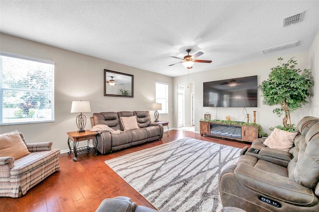 10833 Breaking Rocks Dr, Tampa, FL 33647 - living room featuring a ceiling fan, wood finished floors, a textured ceiling, and baseboards