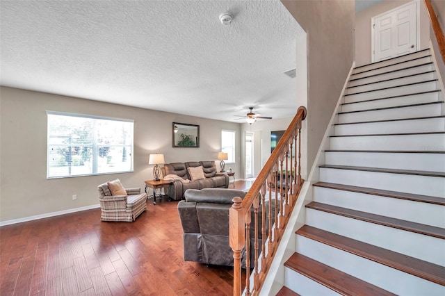 10833 Breaking Rocks Dr, Tampa, FL 33647 - living area featuring wood finished floors, stairs, a ceiling fan, baseboards, and a textured ceiling