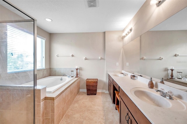 10833 Breaking Rocks Dr, Tampa, FL 33647 - full bathroom featuring tile patterned floors, a garden tub, double vanity, baseboards, and a shower