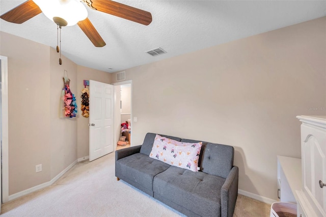 10833 Breaking Rocks Dr, Tampa, FL 33647 - living area featuring light colored carpet, a ceiling fan, baseboards, and a textured ceiling