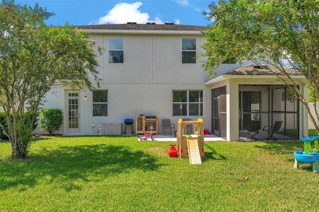10833 Breaking Rocks Dr, Tampa, FL 33647 - rear view of house with a lawn, stucco siding, and a sunroom