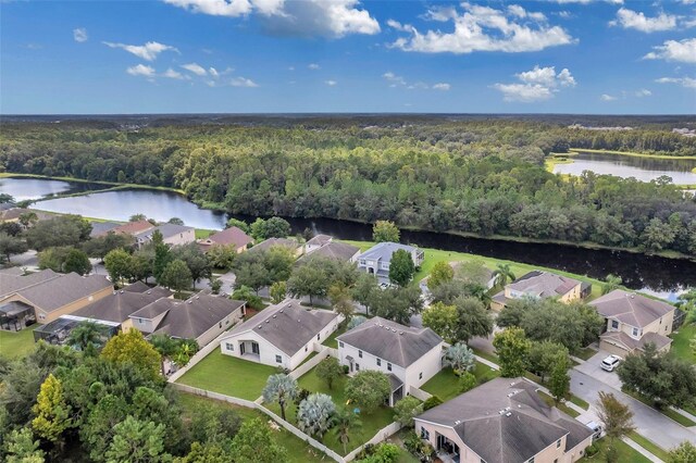 10833 Breaking Rocks Dr, Tampa, FL 33647 - aerial perspective of suburban area featuring a forest and a nearby body of water
