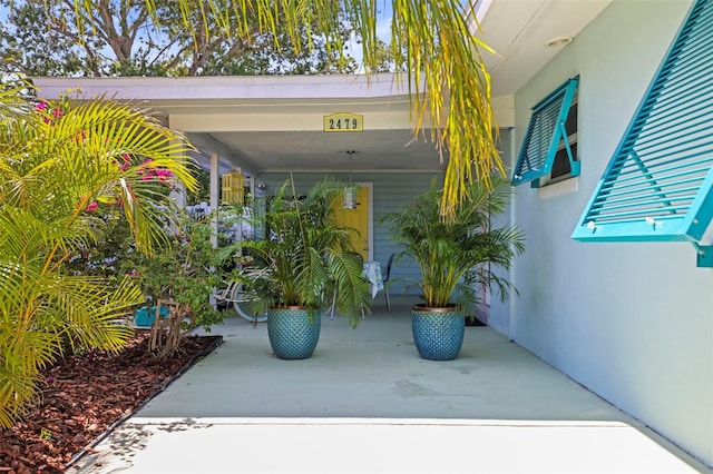 2479 Trade Winds Dr, Dunedin, FL 34698 - view of exterior entry featuring stucco siding