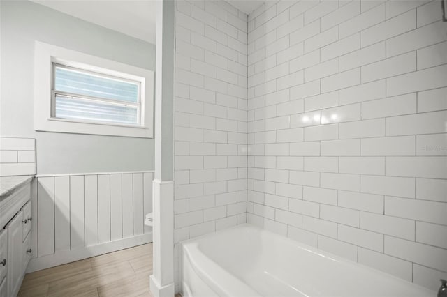 2479 Trade Winds Dr, Dunedin, FL 34698 - bathroom with toilet, vanity, wood finished floors, and  shower combination