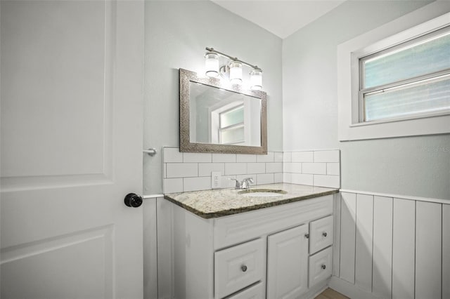 2479 Trade Winds Dr, Dunedin, FL 34698 - bathroom featuring vanity, wainscoting, and decorative backsplash