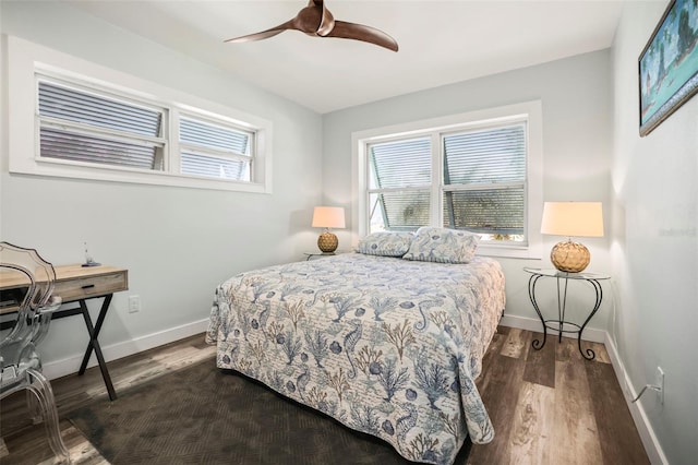 2479 Trade Winds Dr, Dunedin, FL 34698 - bedroom featuring dark wood finished floors, baseboards, and a ceiling fan