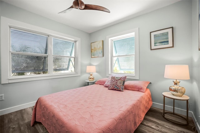 2479 Trade Winds Dr, Dunedin, FL 34698 - bedroom featuring multiple windows, baseboards, wood finished floors, and a ceiling fan