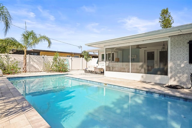 2479 Trade Winds Dr, Dunedin, FL 34698 - view of swimming pool featuring a fenced backyard, a sunroom, ceiling fan, and a patio area