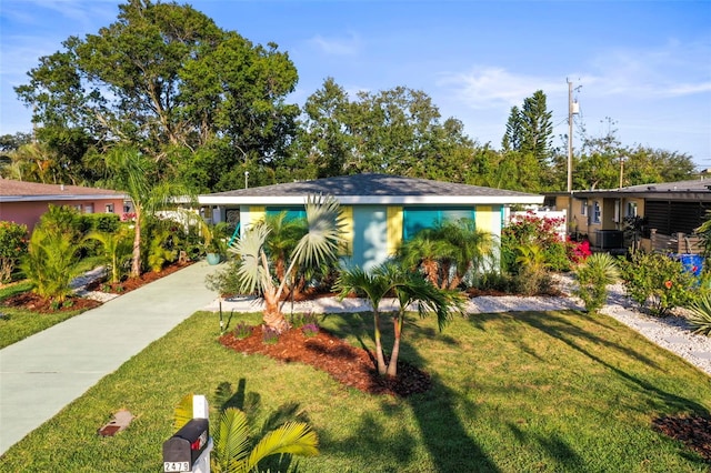 2479 Trade Winds Dr, Dunedin, FL 34698 - view of front of home featuring a front lawn and central AC unit