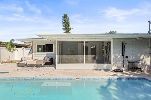 2479 Trade Winds Dr, Dunedin, FL 34698 - rear view of house with a patio area, stucco siding, and a sunroom