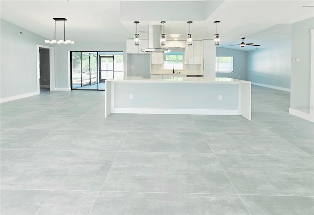 1178 Sultana St, Port Charlotte, FL 33952 - kitchen featuring white cabinetry, open floor plan, ceiling fan, and healthy amount of natural light