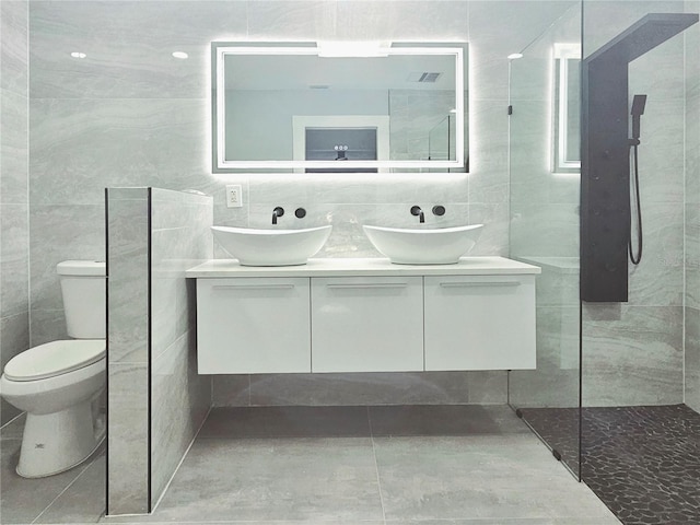 1178 Sultana St, Port Charlotte, FL 33952 - bathroom featuring tile walls, toilet, double vanity, and walk in shower
