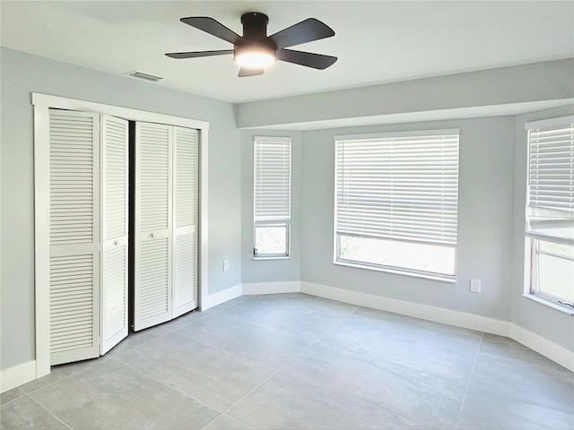 1178 Sultana St, Port Charlotte, FL 33952 - unfurnished bedroom with baseboards, a closet, a ceiling fan, and light tile patterned floors