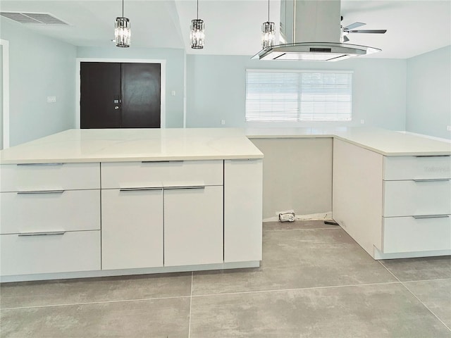 1178 Sultana St, Port Charlotte, FL 33952 - kitchen featuring white cabinets, concrete floors, hanging light fixtures, and ceiling fan