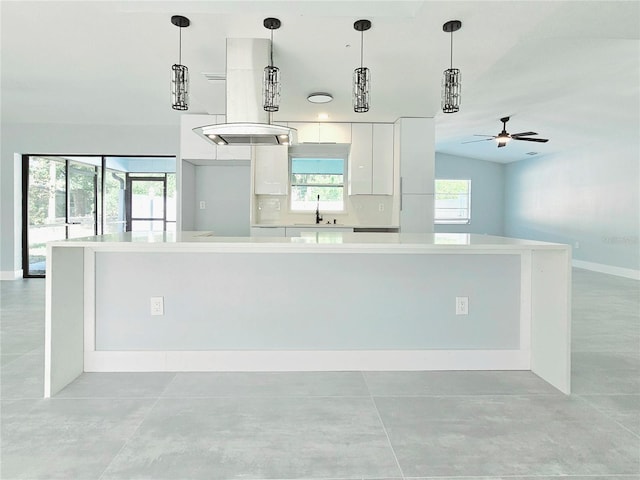1178 Sultana St, Port Charlotte, FL 33952 - kitchen with white cabinetry, a ceiling fan, light countertops, a sink, and baseboards