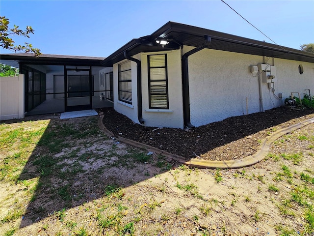 1178 Sultana St, Port Charlotte, FL 33952 - view of side of home with a sunroom and stucco siding