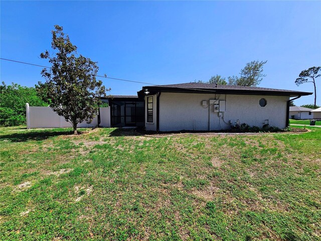 1178 Sultana St, Port Charlotte, FL 33952 - back of property featuring a sunroom and stucco siding