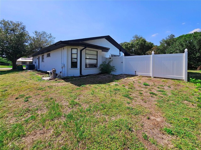 1178 Sultana St, Port Charlotte, FL 33952 - view of property exterior with a gate and stucco siding