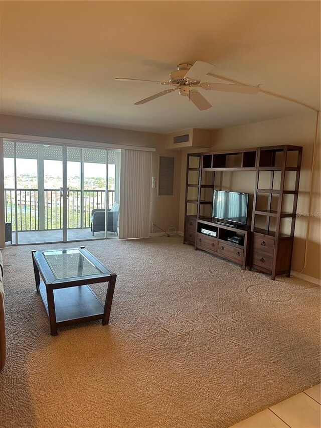 10355 Paradise Blvd Unit 907, Treasure Island, FL 33706 - carpeted living room featuring a ceiling fan
