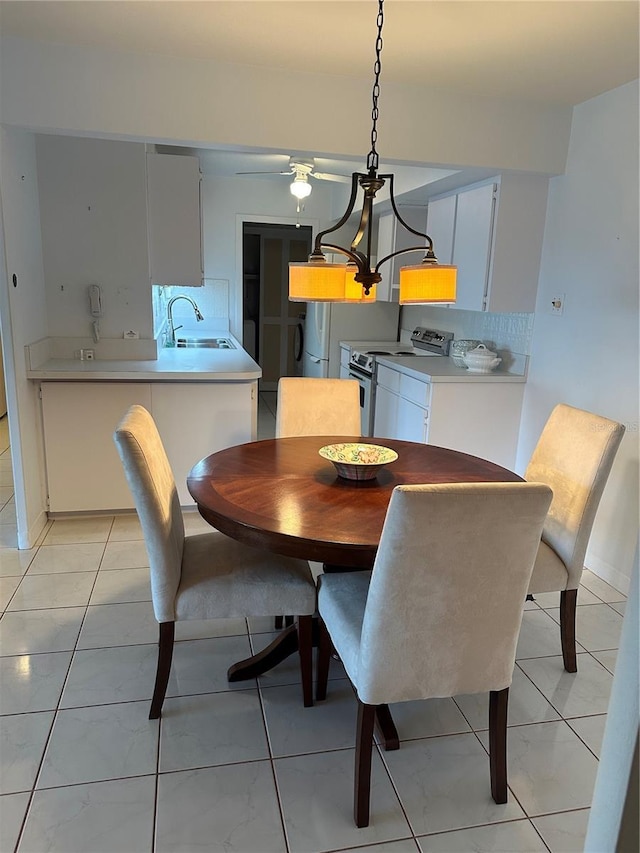 10355 Paradise Blvd Unit 907, Treasure Island, FL 33706 - dining room featuring a ceiling fan and light tile patterned floors