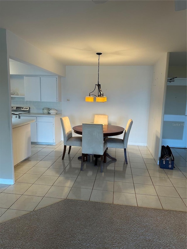 10355 Paradise Blvd Unit 907, Treasure Island, FL 33706 - dining space with light tile patterned floors and baseboards