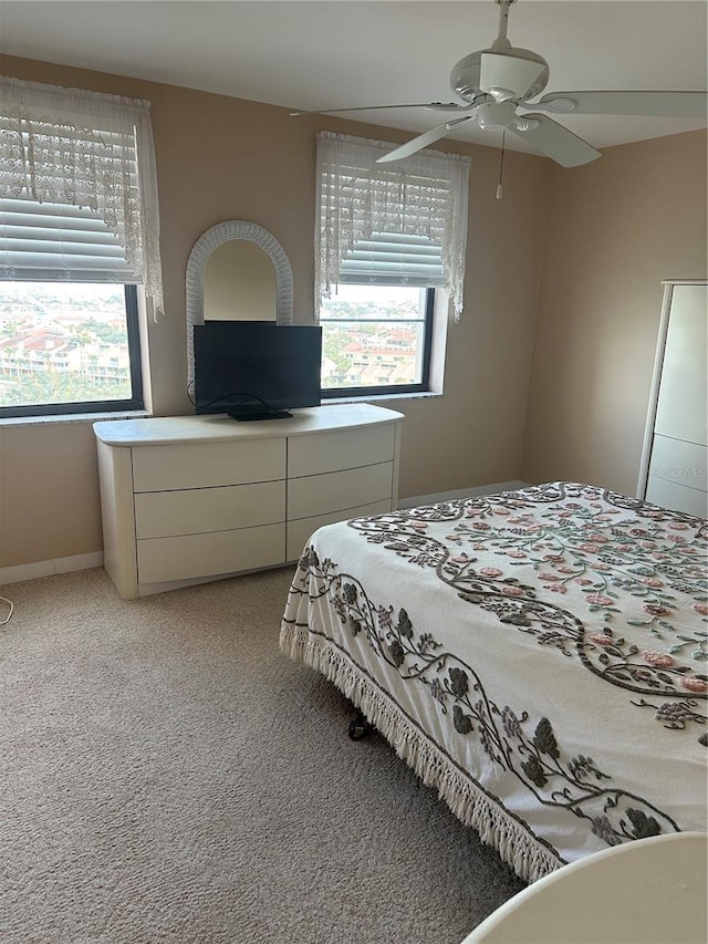 10355 Paradise Blvd Unit 907, Treasure Island, FL 33706 - bedroom featuring multiple windows, light colored carpet, and ceiling fan