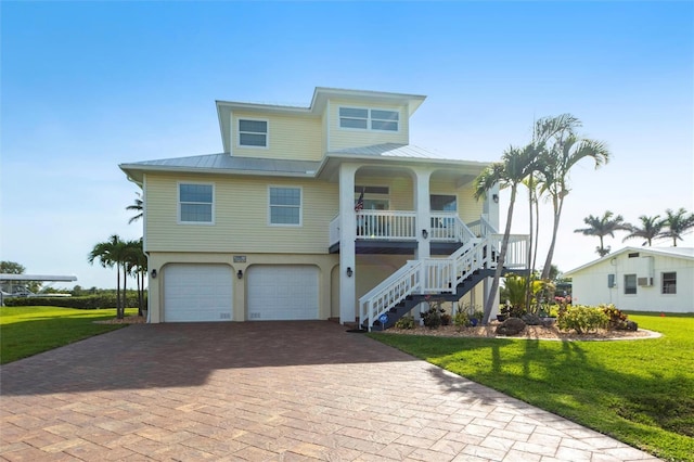 24197 Treasure Island Blvd, Punta Gorda, FL 33955 - beach home featuring covered porch, stairway, decorative driveway, and a front yard