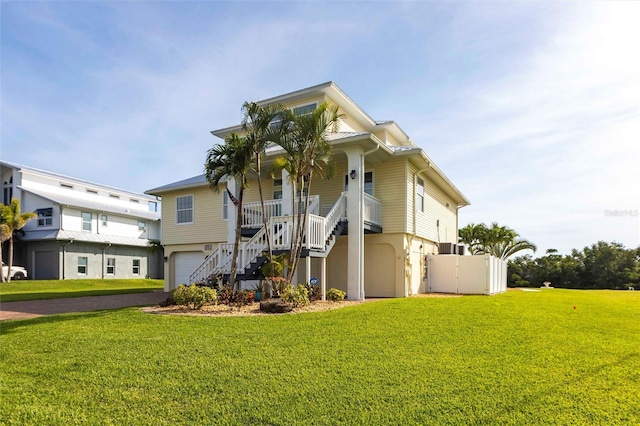 24197 Treasure Island Blvd, Punta Gorda, FL 33955 - view of building exterior with stairway, an attached garage, and asphalt driveway