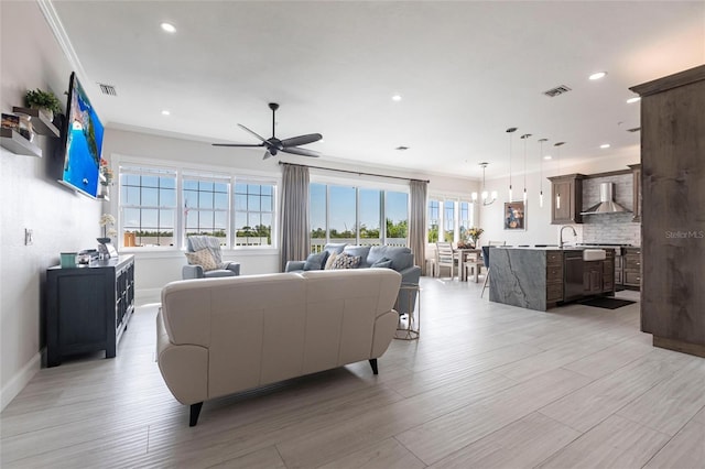 24197 Treasure Island Blvd, Punta Gorda, FL 33955 - living area with light wood-style floors, a ceiling fan, recessed lighting, and crown molding