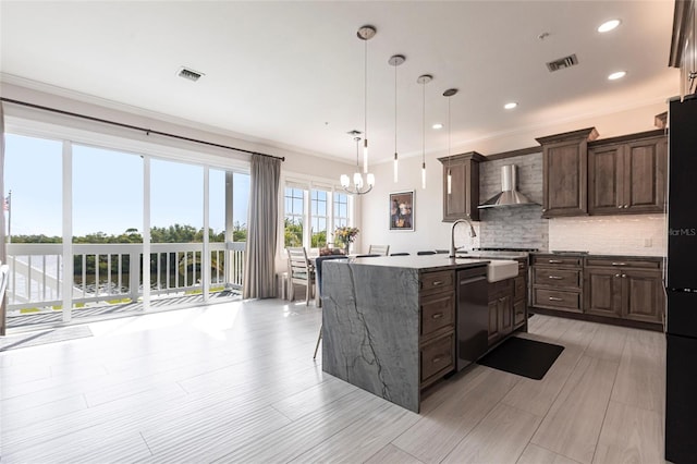 24197 Treasure Island Blvd, Punta Gorda, FL 33955 - kitchen with wall chimney range hood, stainless steel dishwasher, decorative backsplash, dark brown cabinets, and a center island with sink