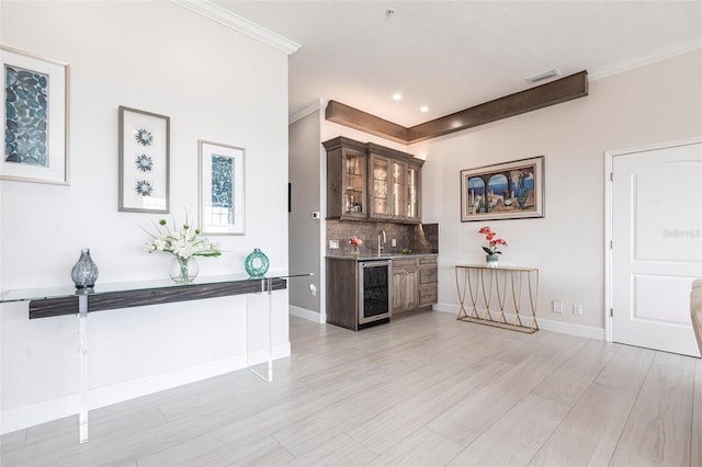 24197 Treasure Island Blvd, Punta Gorda, FL 33955 - indoor wet bar with wine cooler, tasteful backsplash, light wood-style floors, crown molding, and recessed lighting