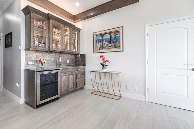 24197 Treasure Island Blvd, Punta Gorda, FL 33955 - indoor wet bar featuring beverage cooler, backsplash, light wood-style flooring, and recessed lighting