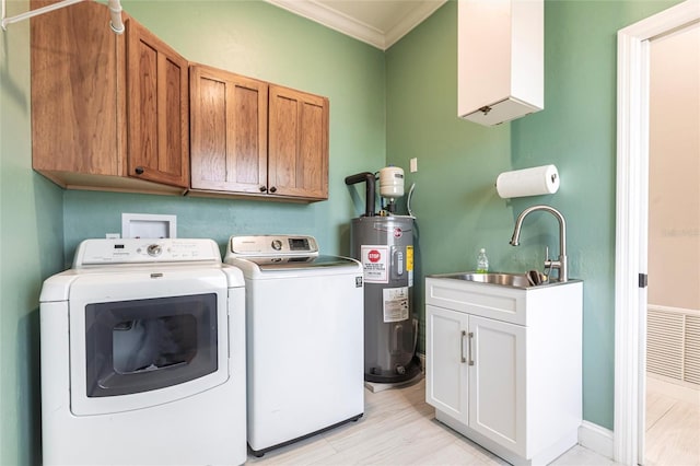 24197 Treasure Island Blvd, Punta Gorda, FL 33955 - washroom with washing machine and clothes dryer, electric water heater, crown molding, cabinet space, and light wood-style floors